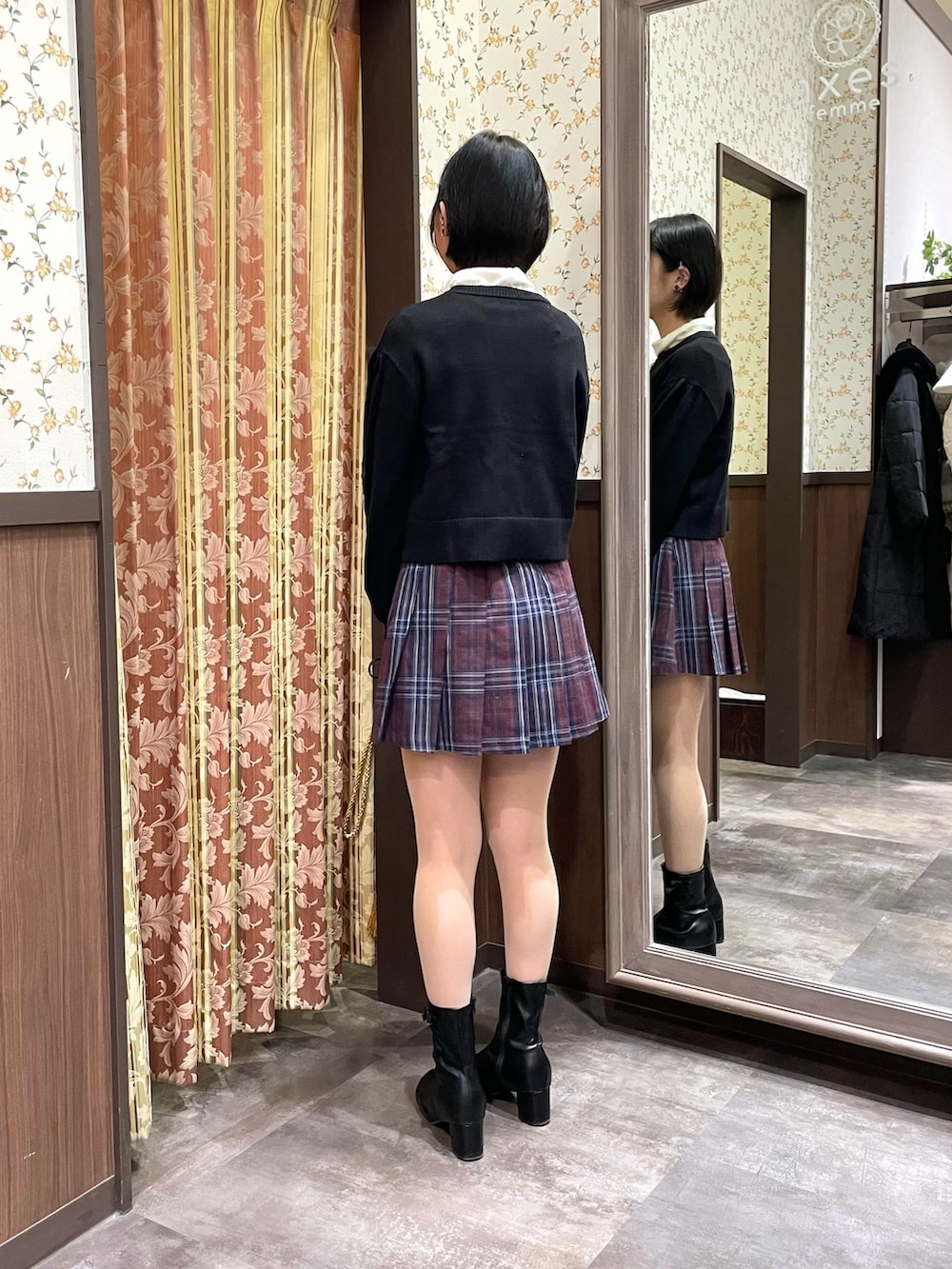 レッド系のその他パンツ、ブラック系のカーディガン/ボレロ、ブラック系のブーツを着用したレディースの冬コーディネートの3枚目の写真