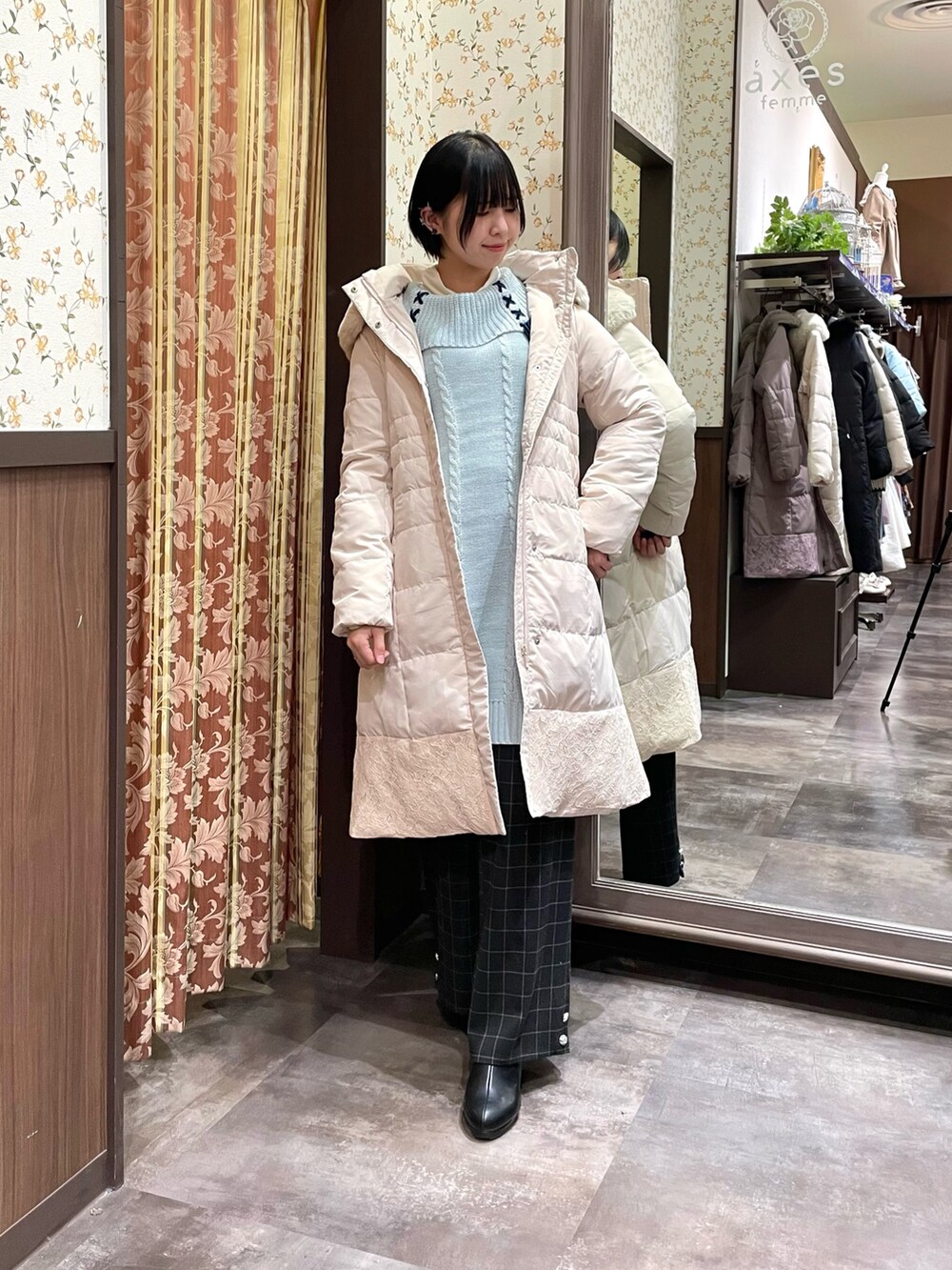 ベージュ系のダウンジャケット/コート、グリーン系のチュニック、ブラック系のその他パンツを着用したレディースの冬コーディネートの2枚目の写真