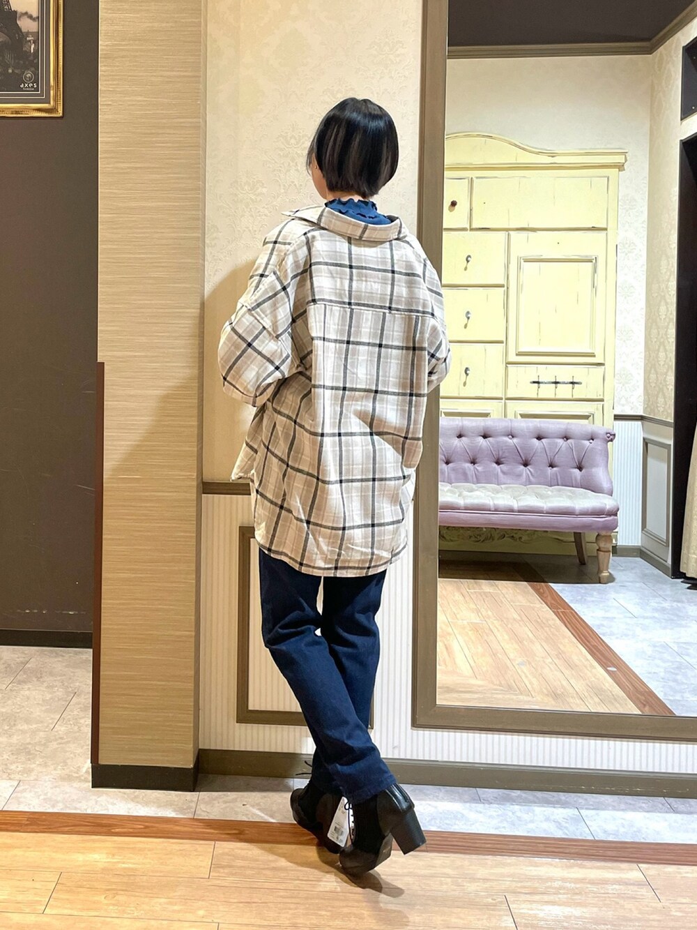 ブルー系のデニムパンツ、ブラック系のブーツ、ブルー系のTシャツ/カットソーを着用したレディースの秋コーディネートの4枚目の写真