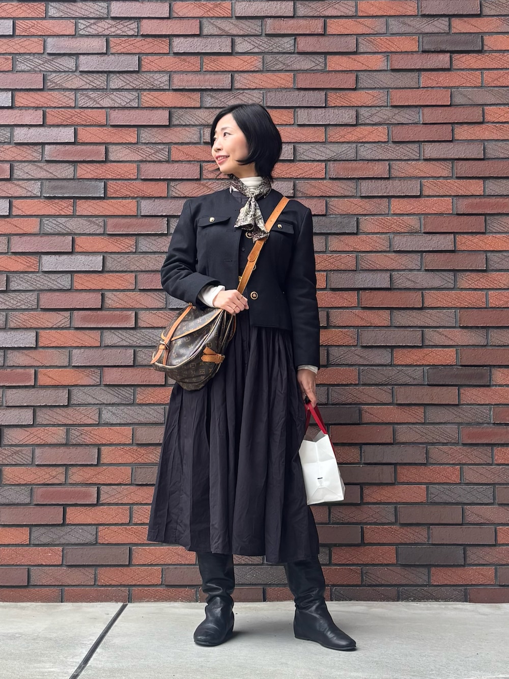 ホワイト系のTシャツ/カットソー、ブラック系のノーカラージャケット、ブラック系のシャツワンピースを着用したレディースの冬コーディネートの2枚目の写真