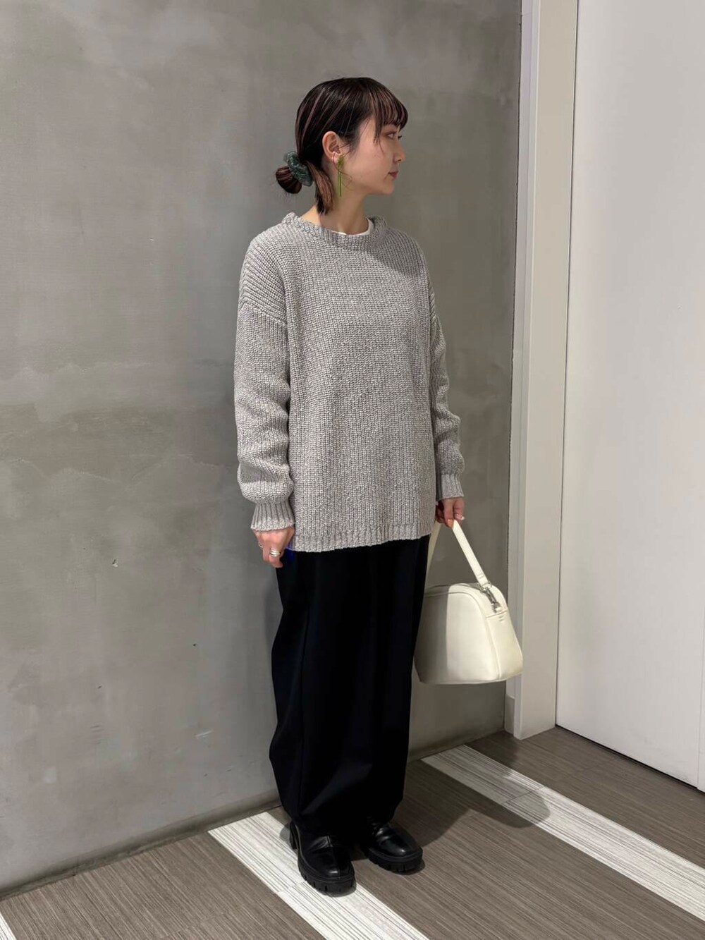 ホワイト系のTシャツ/カットソー、ホワイト系のショルダーバッグ、ブラック系のその他パンツを着用したレディースの冬コーディネートの2枚目の写真