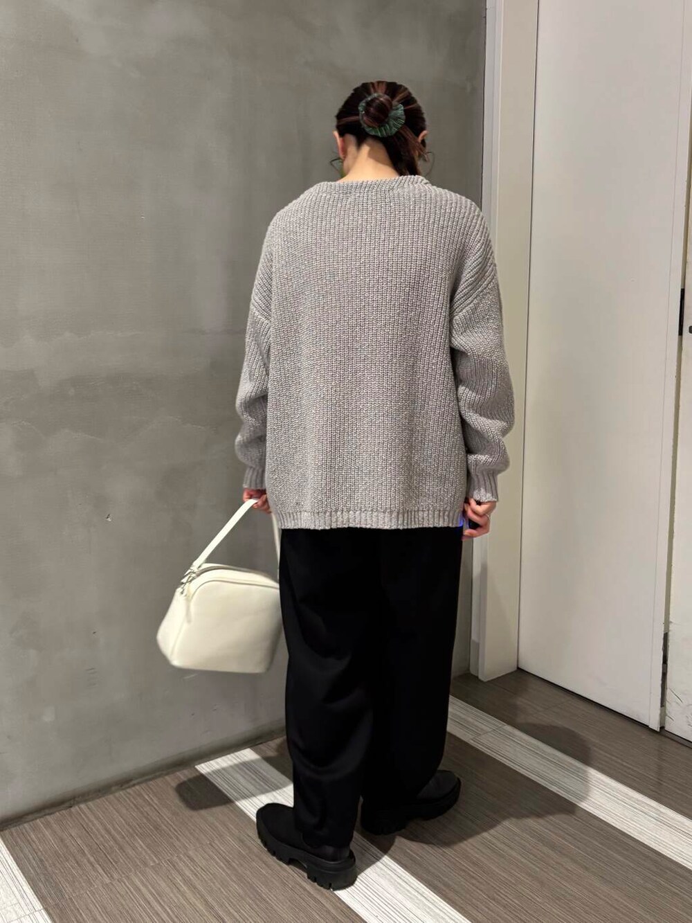 ホワイト系のTシャツ/カットソー、ホワイト系のショルダーバッグ、ブラック系のその他パンツを着用したレディースの冬コーディネートの5枚目の写真