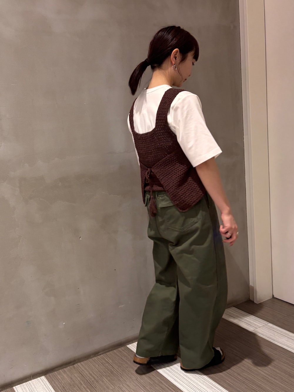 グリーン系のその他パンツ、ブラウン系のタンクトップ、ホワイト系のTシャツ/カットソーを着用したレディースの春コーディネートの4枚目の写真