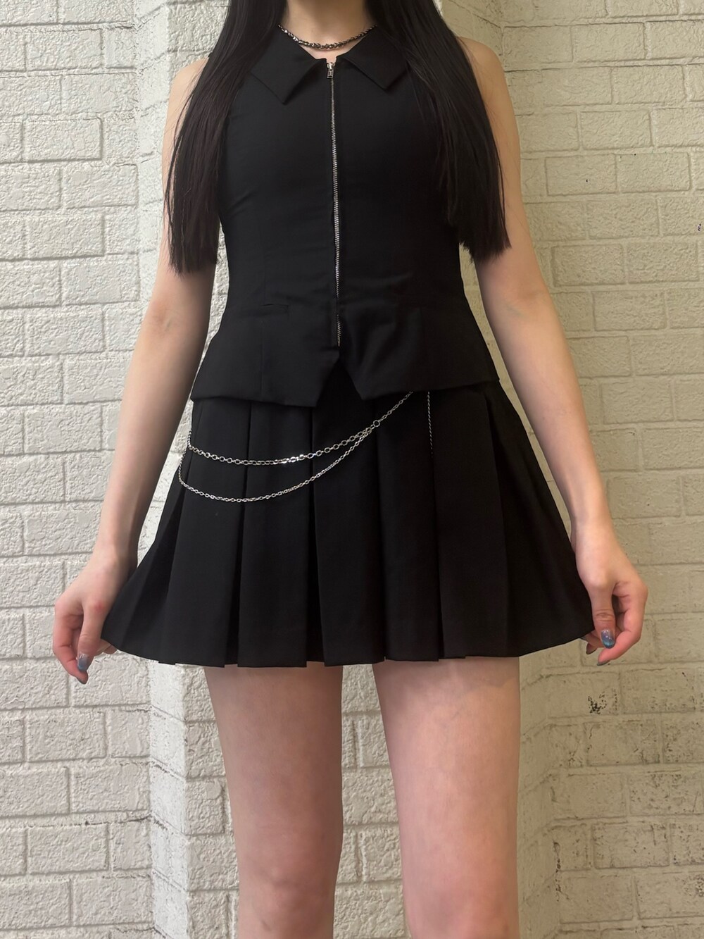 ブラック系のニット/セーター、ホワイト系のサンダル、ブラック系のワンピースを着用したレディースの春コーディネートの4枚目の写真