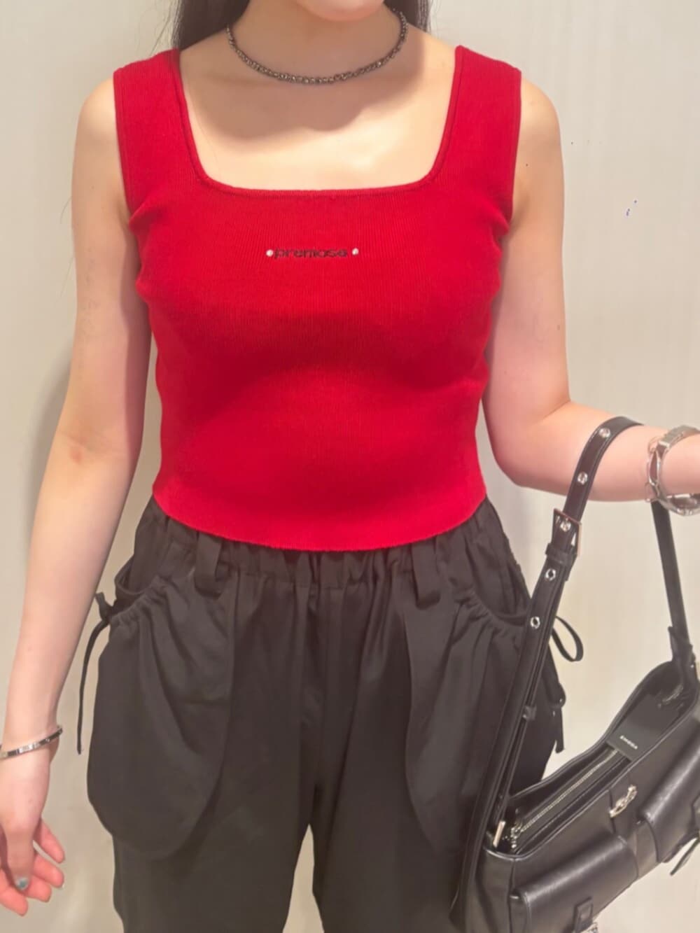 ブラック系のハンドバッグ、ブラック系のその他パンツ、レッド系のTシャツ/カットソーを着用したレディースの夏コーディネートの4枚目の写真