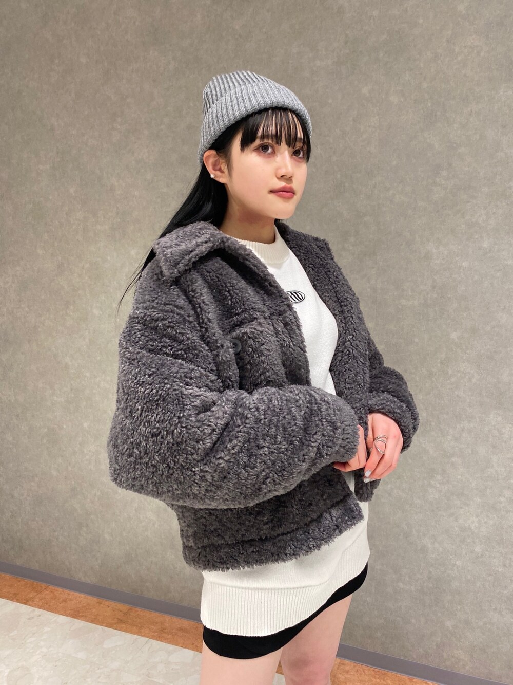 ブラック系のブーツ、グレー系のブルゾン、ホワイト系のニット/セーターを着用したレディースの冬コーディネートの4枚目の写真