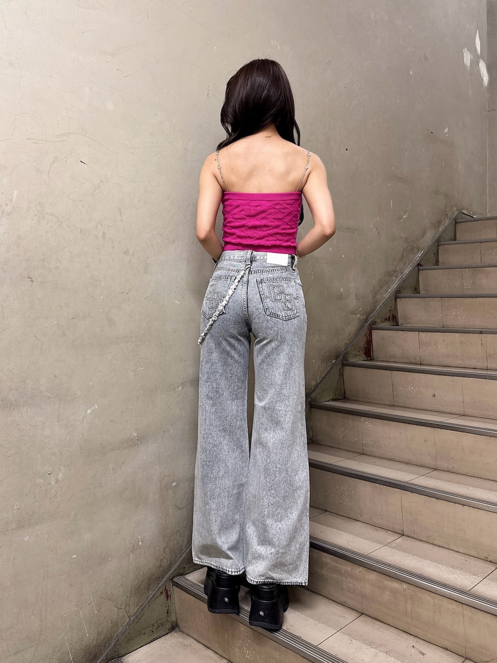 ピンク系のキャミソール、ブルー系のデニムパンツ、ブラック系のサンダルを着用したレディースの夏コーディネートの3枚目の写真