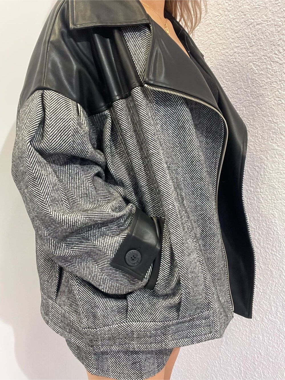 ブラック系のライダースジャケット、ブラック系のニット/セーター、ブラック系のスカートを着用したレディースの秋コーディネートの8枚目の写真