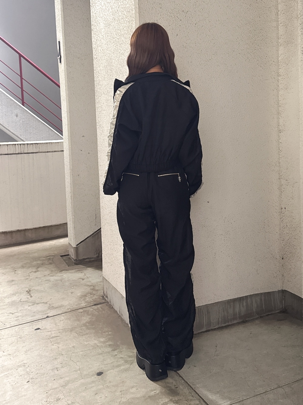 ホワイト系のチューブトップ、ブラック系のブルゾン、ブラック系のその他パンツを着用したレディースの春コーディネートの3枚目の写真