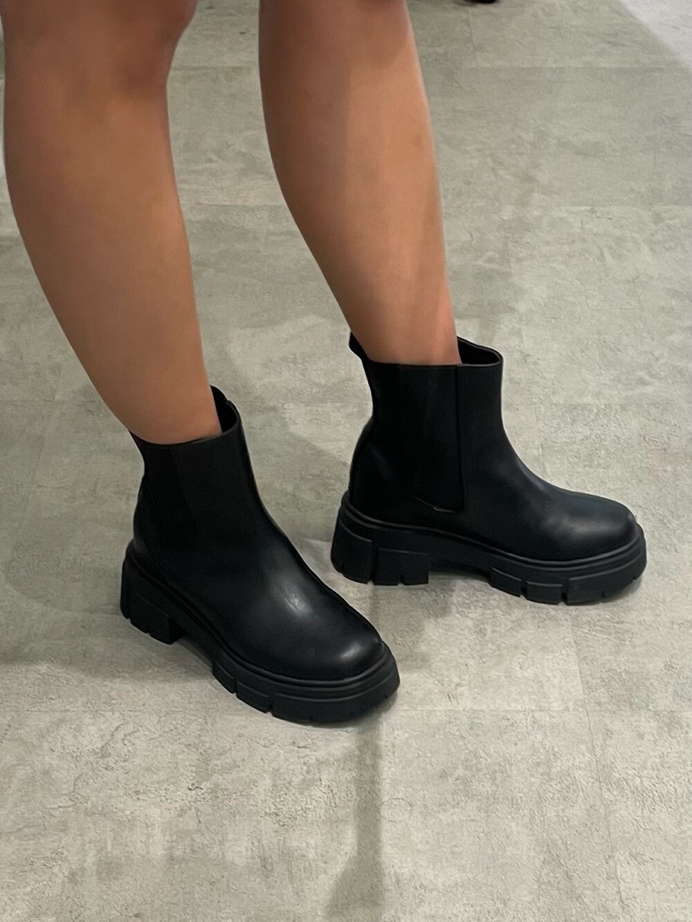 ベージュ系のシャツ/ブラウス、ホワイト系のハンドバッグ、ブラック系のブーツを着用したレディースの春コーディネートの9枚目の写真