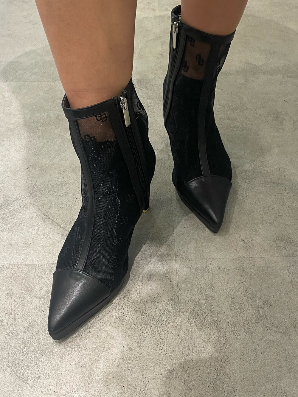 ブラック系のブーツ、ブラック系のハンドバッグ、ブルー系のデニムパンツを着用したレディースの冬コーディネートの9枚目の写真