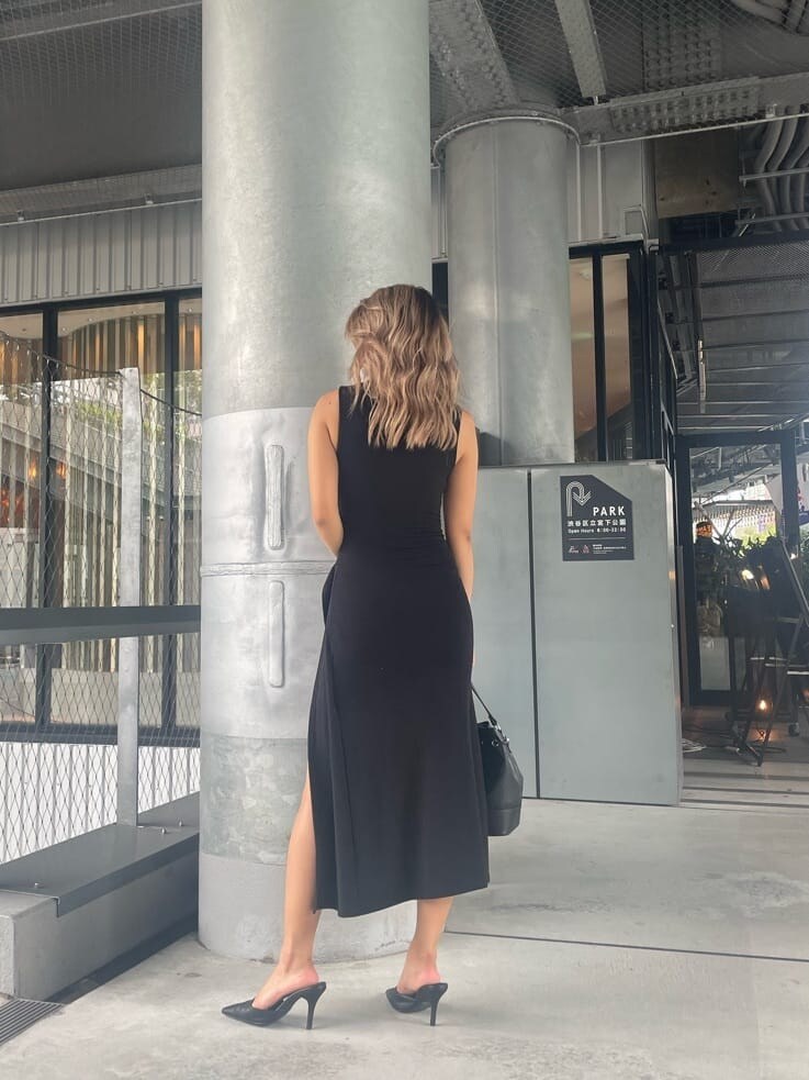 ブラック系のパンプス、ブラック系のワンピース、ブラック系のハンドバッグを着用したレディースの夏コーディネートの3枚目の写真