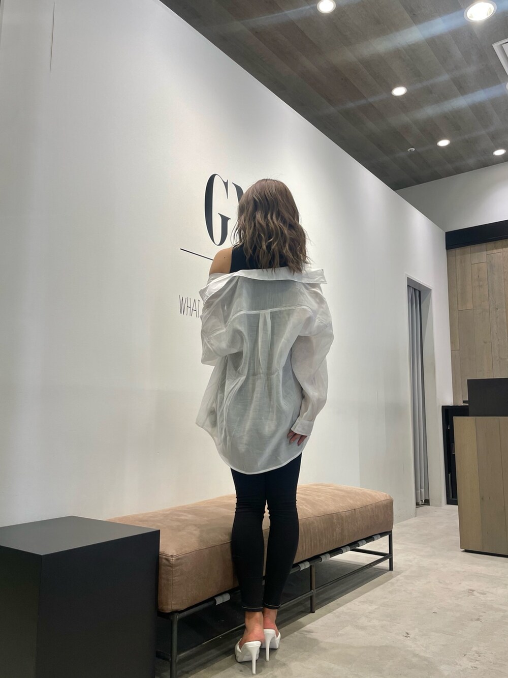 ブラック系のデニムパンツ、ホワイト系のシャツ/ブラウス、ブラック系のタンクトップを着用したレディースの夏コーディネートの3枚目の写真