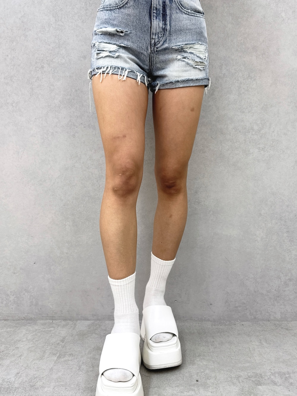 ホワイト系のチューブトップ、ベージュ系のカーディガン/ボレロ、ブルー系のデニムパンツを着用したレディースの夏コーディネートの7枚目の写真