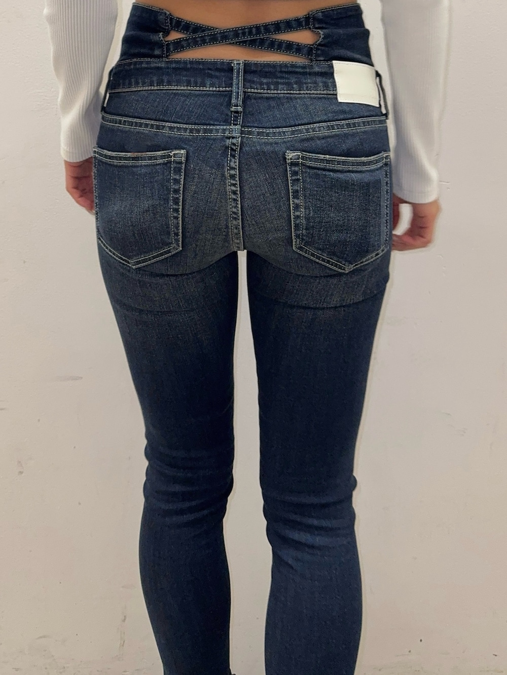 ホワイト系のTシャツ/カットソー、ブラウン系のムートンコート、ブルー系のデニムパンツを着用したレディースの秋コーディネートの7枚目の写真