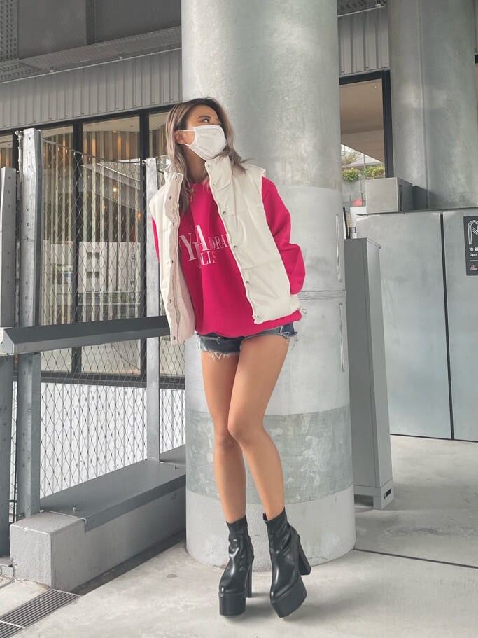 ブルー系のデニムパンツ、ピンク系のスウェット、ブラック系のブーツを着用したレディースの夏コーディネートの3枚目の写真