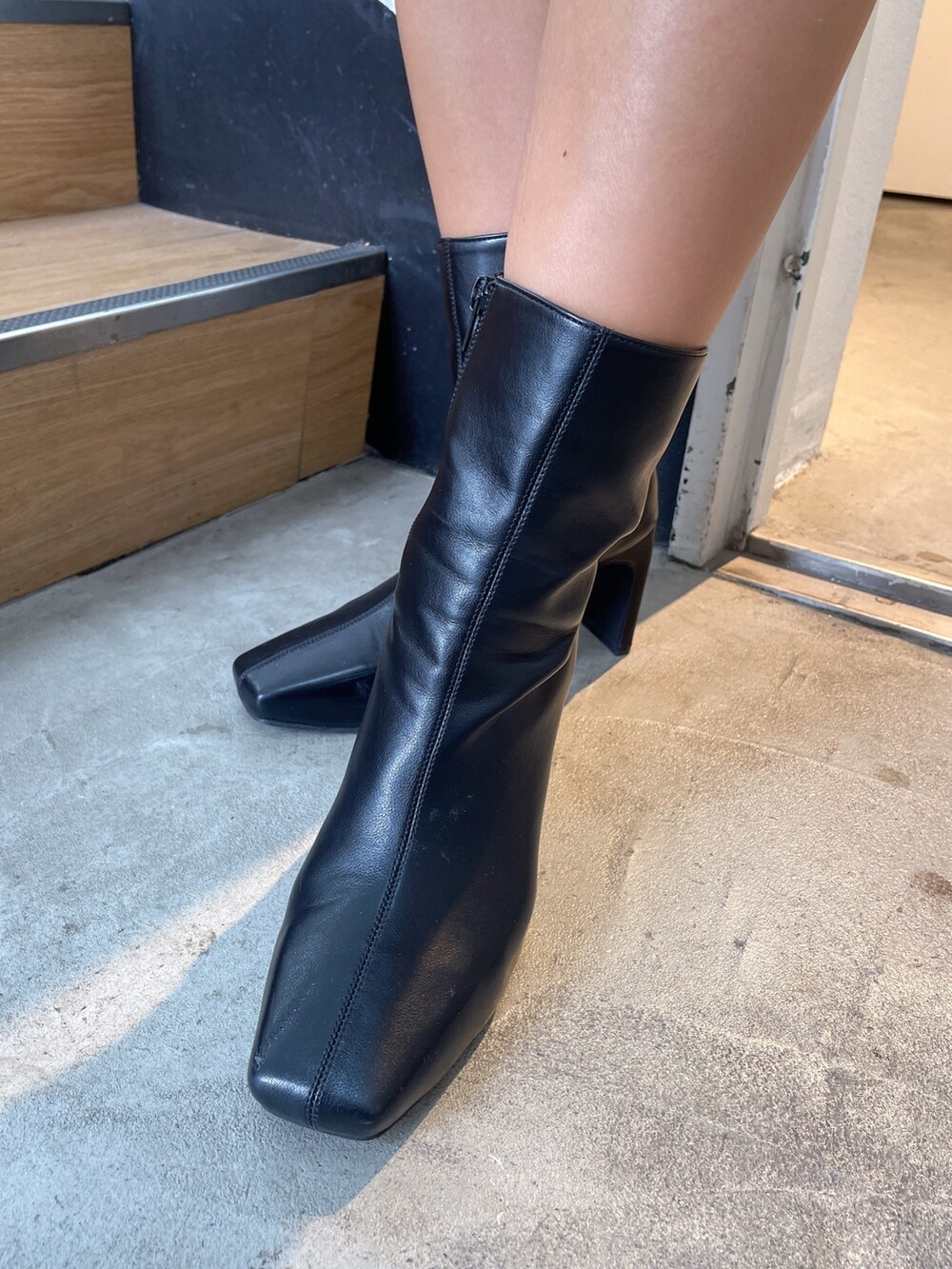 ブラック系のブルゾン、ホワイト系のニット/セーター、ブラック系のその他パンツを着用したレディースの秋コーディネートの9枚目の写真
