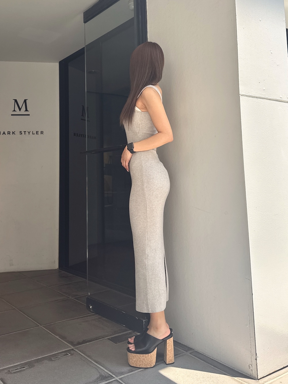 グレー系のワンピース、ブラック系のサンダルを着用したレディースの夏コーディネートの2枚目の写真