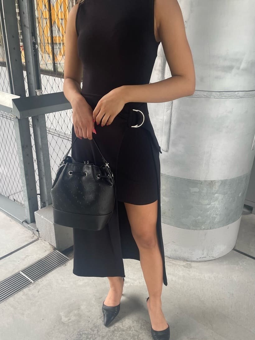 ブラック系のパンプス、ブラック系のワンピース、ブラック系のハンドバッグを着用したレディースの夏コーディネートの4枚目の写真