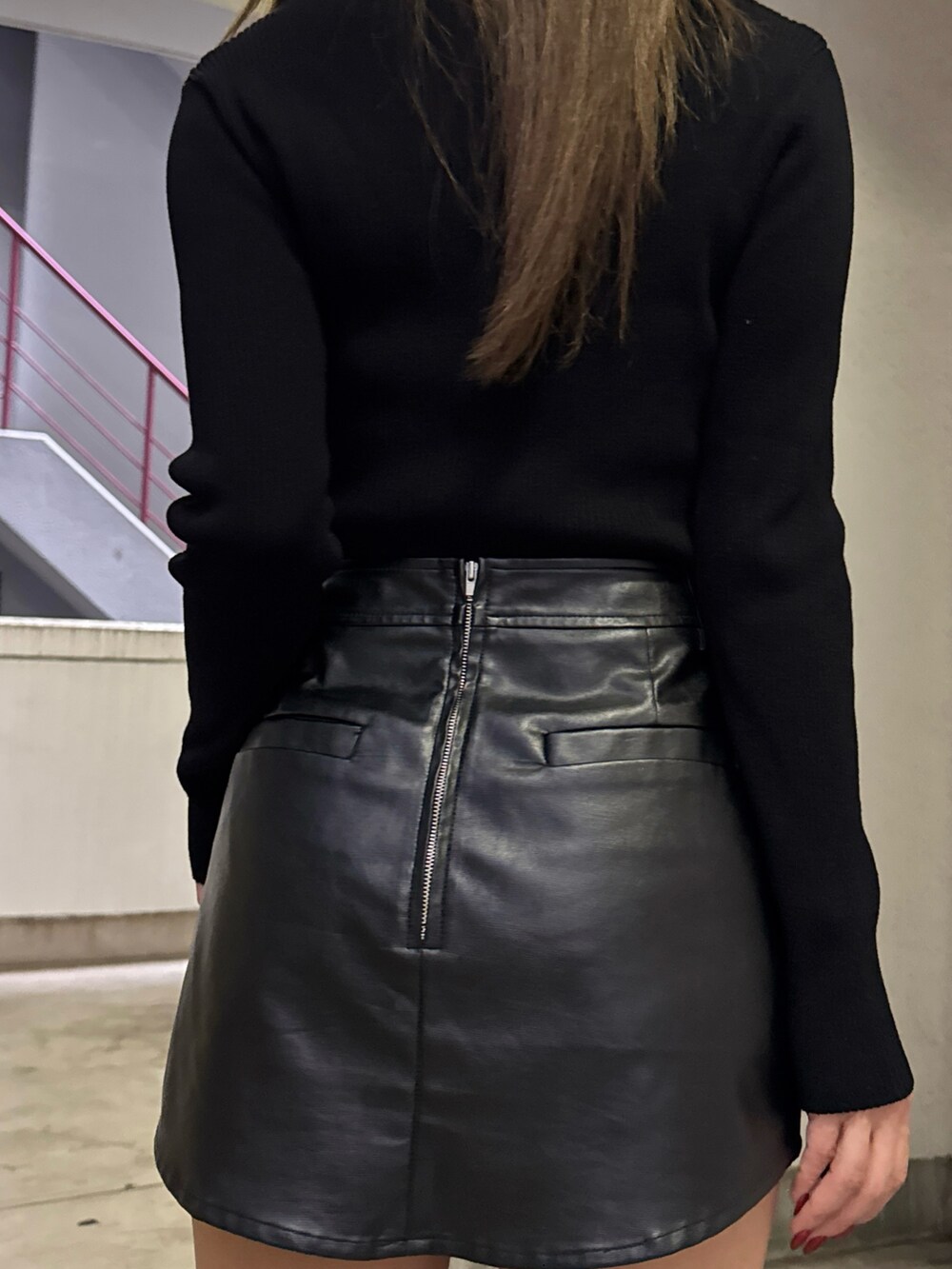 ブラック系のニット/セーター、ブラック系のスカート、ブラック系のブーツを着用したレディースの秋コーディネートの7枚目の写真