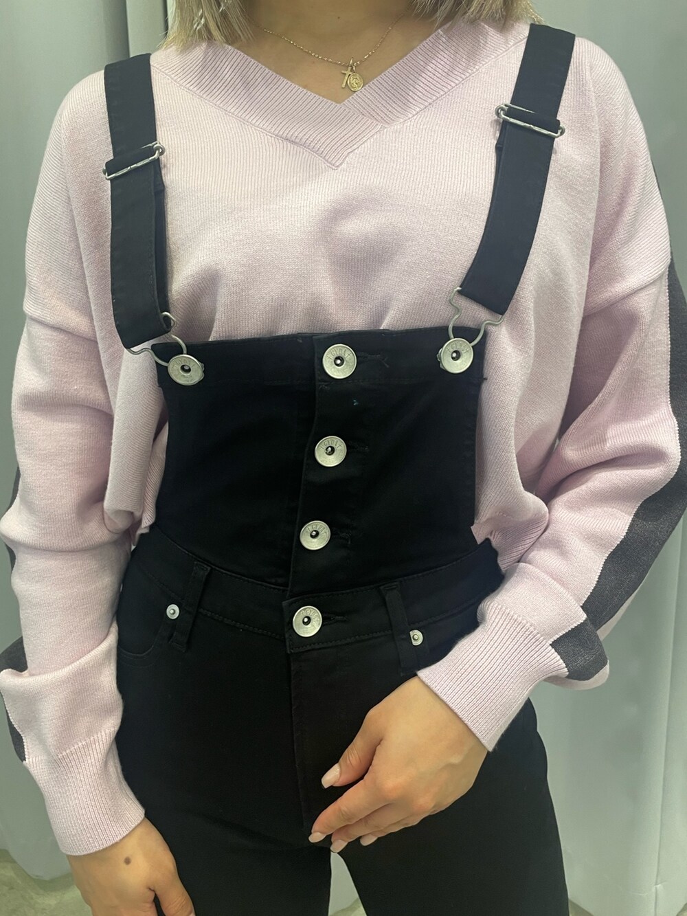 ブラック系のサロペット/オーバーオール、ピンク系のニット/セーター、ブラック系のダウンジャケット/コートを着用したレディースの冬コーディネートの9枚目の写真