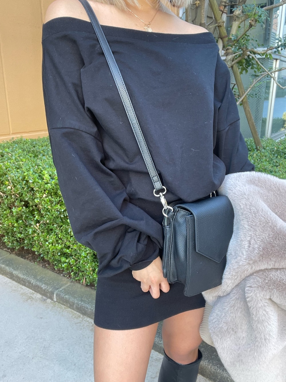 ベージュ系のブルゾン、ブラック系のワンピース、ブラック系のブーツを着用したレディースの冬コーディネートの10枚目の写真