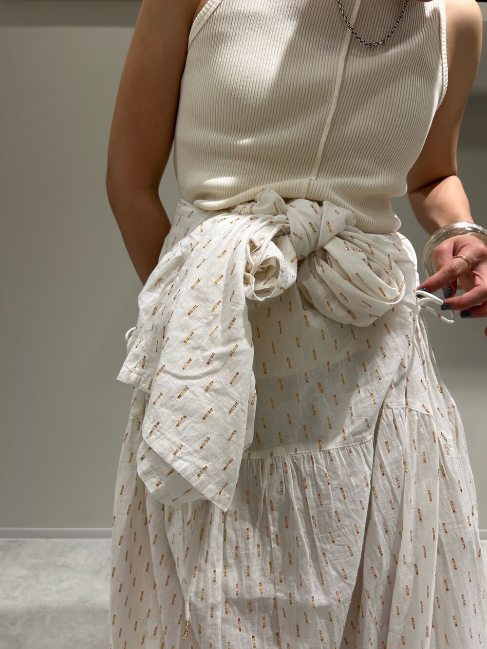 ホワイト系のワンピース、ホワイト系のタンクトップ、シルバー系のサンダルを着用したレディースの夏コーディネートの7枚目の写真