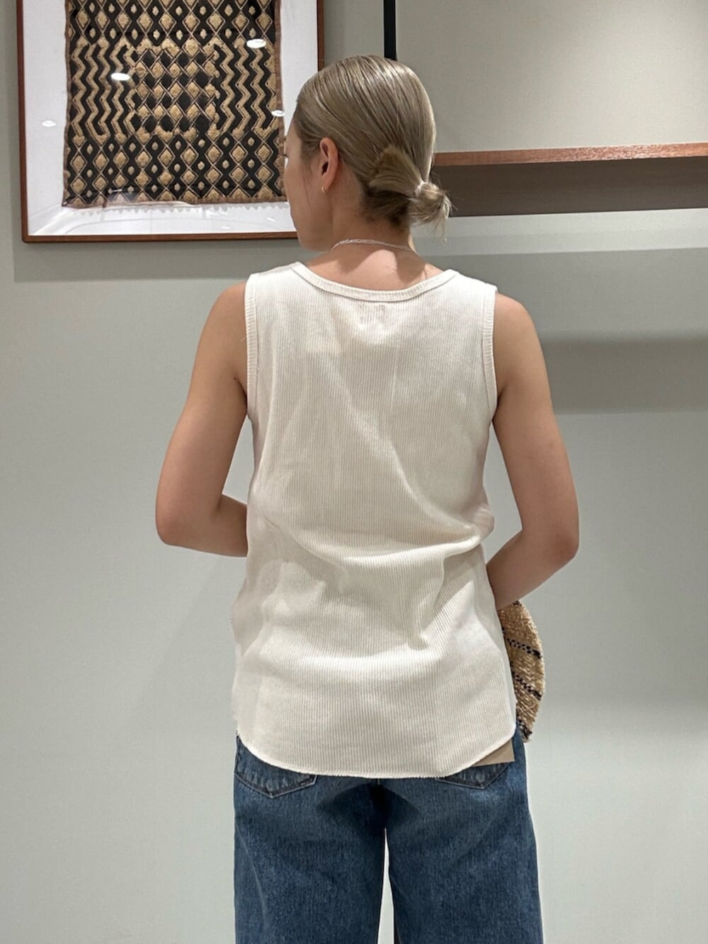 ホワイト系のサンダル、ブルー系のデニムパンツ、ホワイト系のタンクトップを着用したレディースの夏コーディネートの5枚目の写真