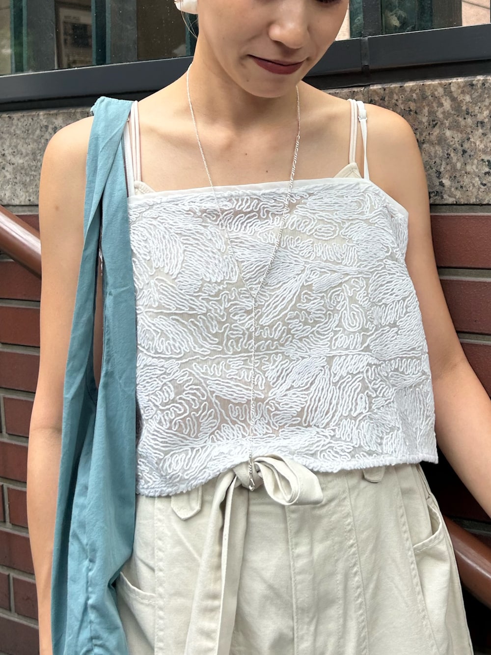 ホワイト系のその他パンツ、ホワイト系のキャミソール、ブルー系のトートバッグを着用したレディースの夏コーディネートの6枚目の写真