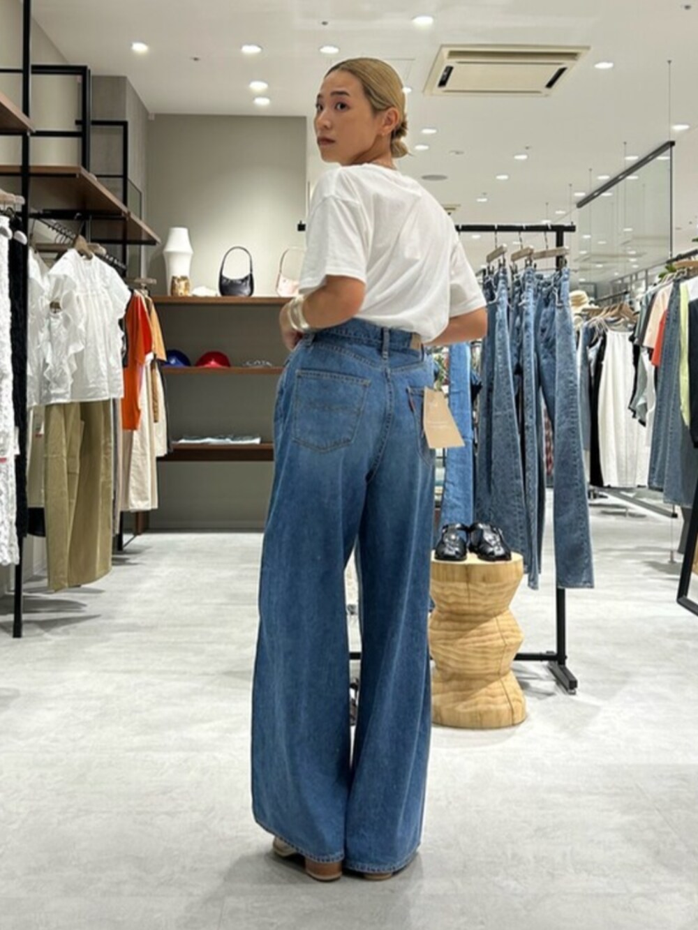 ホワイト系のサンダル、ブルー系のデニムパンツ、ホワイト系のTシャツ/カットソーを着用したレディースの夏コーディネートの3枚目の写真