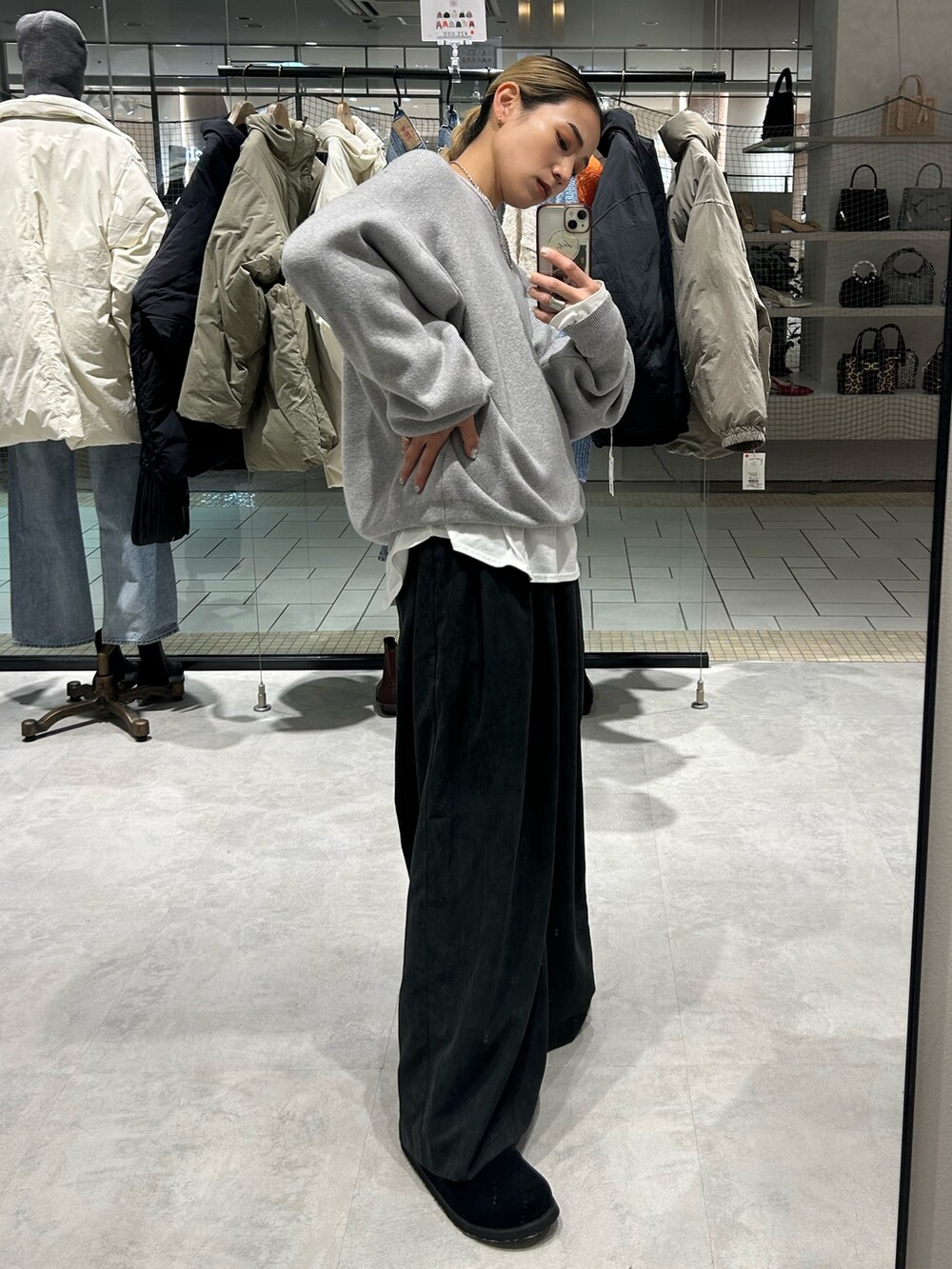 グレー系のニット/セーター、ホワイト系のTシャツ/カットソー、グレー系のその他パンツを着用したレディースの冬コーディネートの2枚目の写真