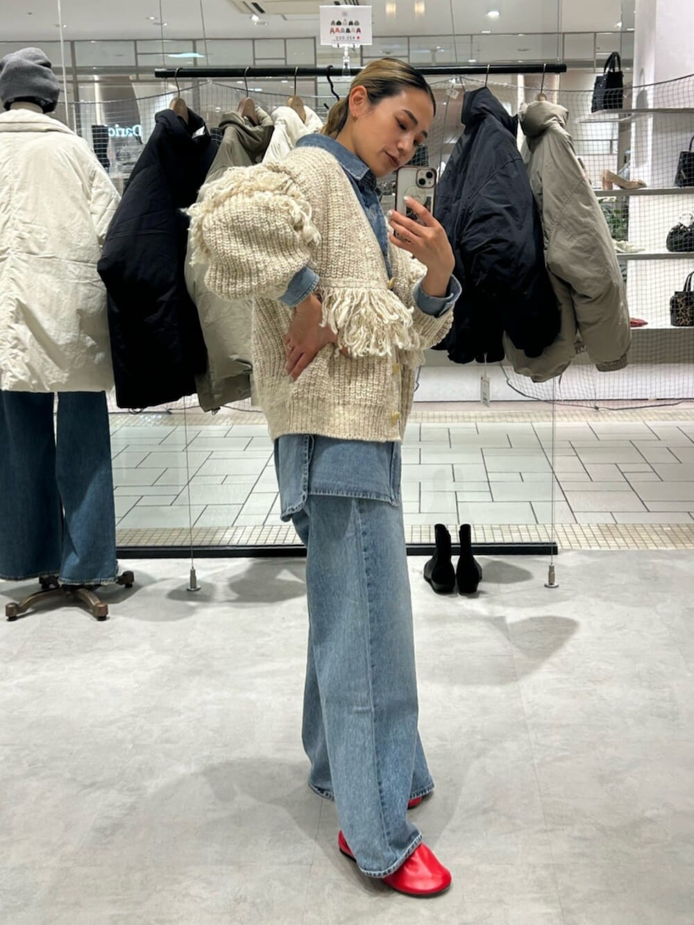 ブルー系のデニムパンツ、ホワイト系のカーディガン/ボレロ、ブルー系のシャツ/ブラウスを着用したレディースの冬コーディネートの2枚目の写真