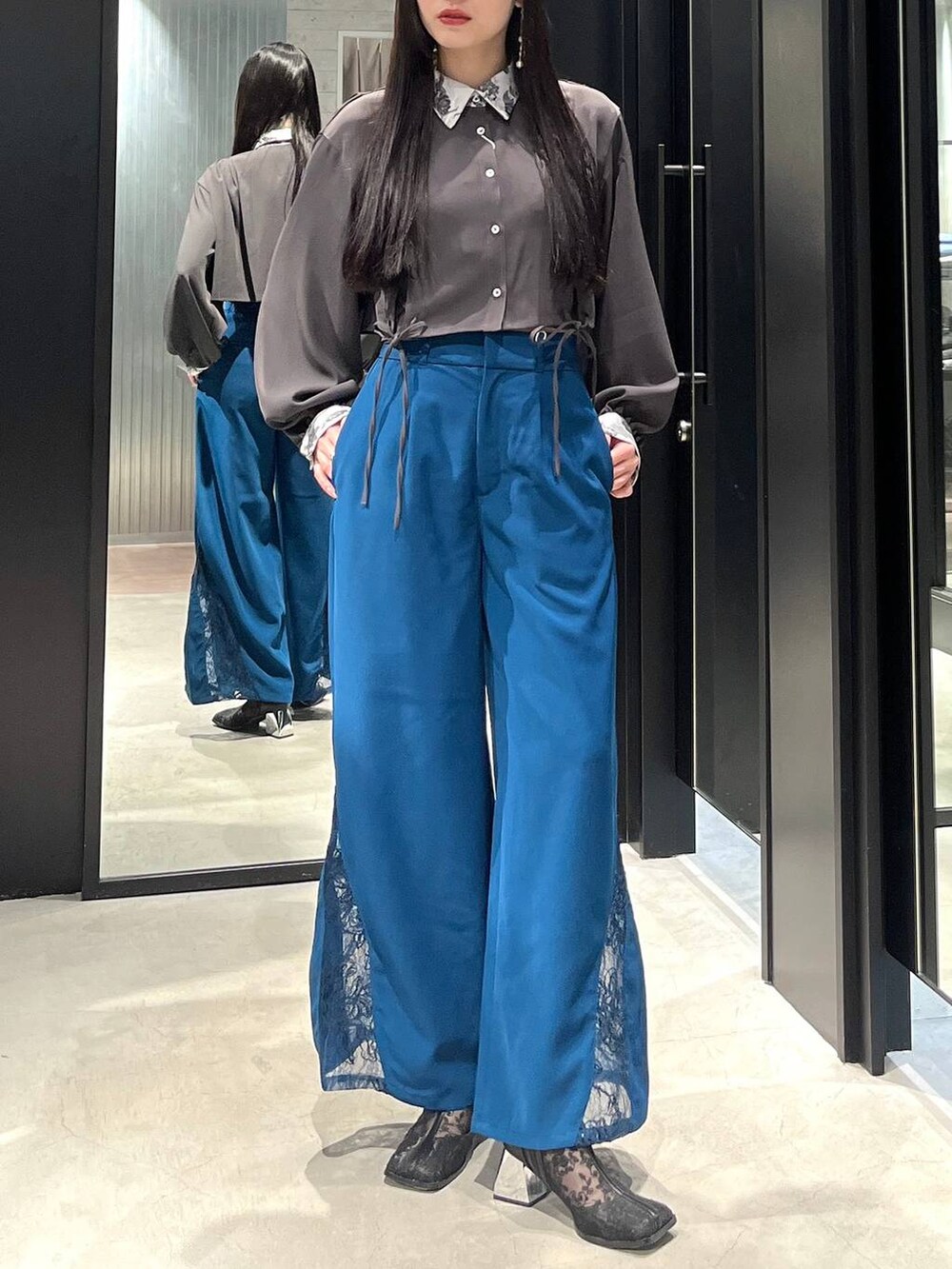 ブラック系のブーツ、ホワイト系のシャツ/ブラウス、ブルー系のその他パンツを着用したレディースの春コーディネートの2枚目の写真