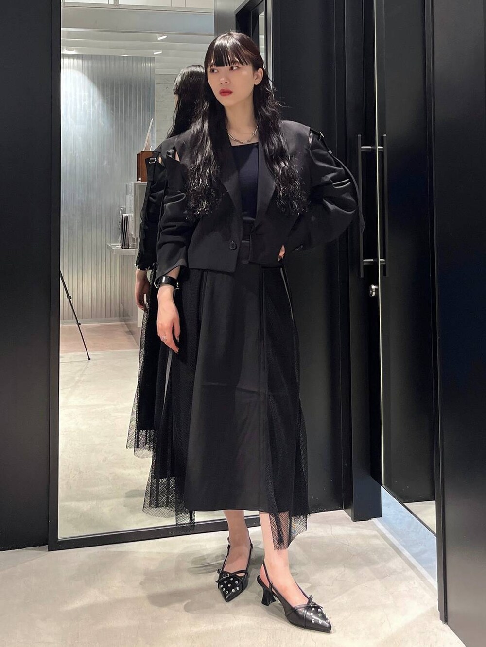 ブラック系のスカート、ブラック系のパンプス、ブラック系のテーラードジャケットを着用したレディースの夏コーディネートの2枚目の写真