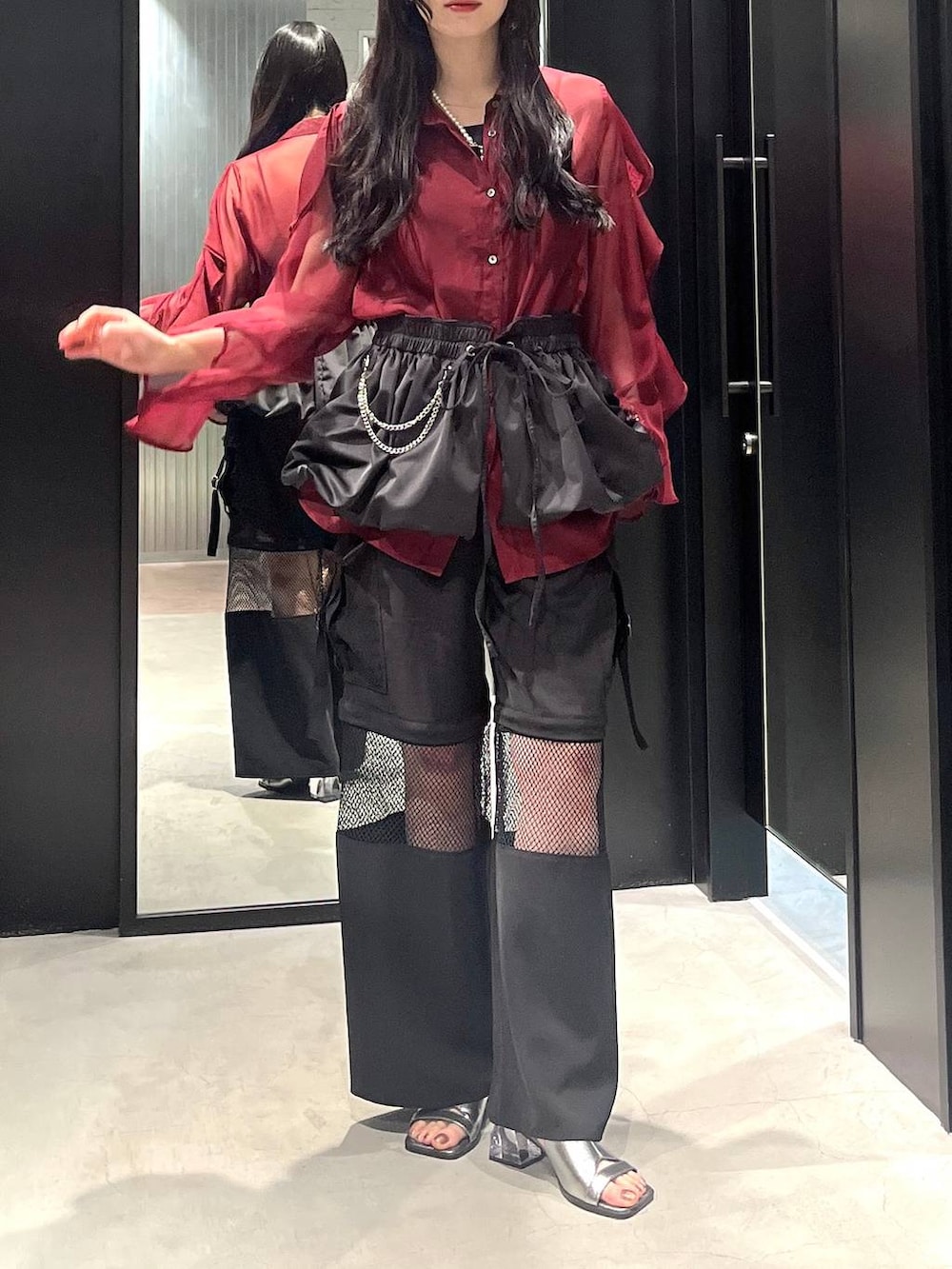 レッド系のシャツ/ブラウス、シルバー系のサンダル、ブラック系のカーゴパンツを着用したレディースの春コーディネートの2枚目の写真