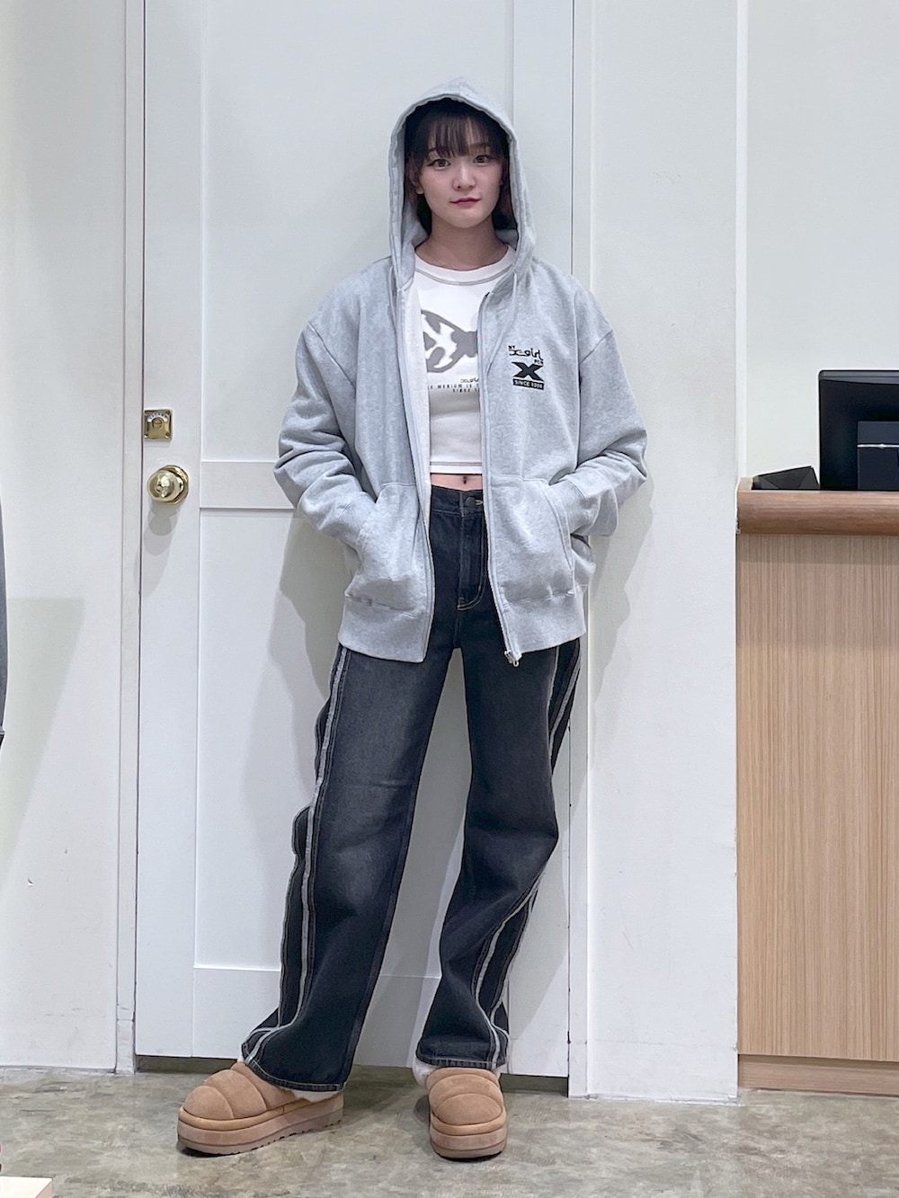 グレー系のパーカー、ホワイト系のTシャツ/カットソー、ブラック系のデニムパンツを着用したメンズの秋コーディネートの2枚目の写真