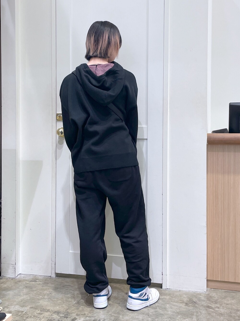 ブルー系のショルダーバッグ、ブラック系のニット/セーター、ブラック系のスウェットパンツを着用したメンズの秋コーディネートの3枚目の写真