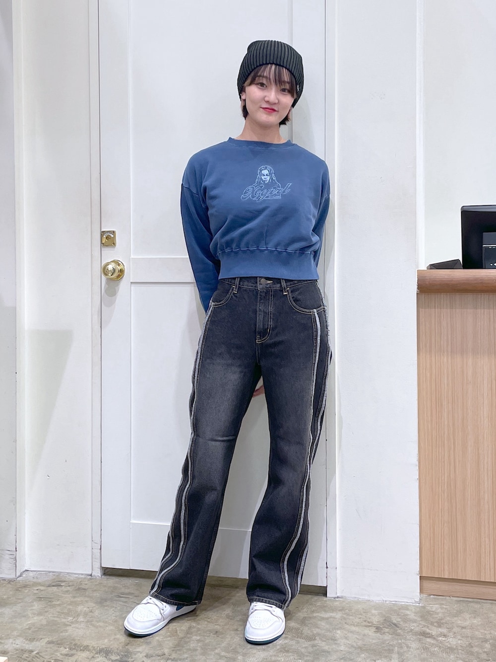 ブルー系のスウェット、ブラック系のデニムパンツ、ブラック系のニットキャップ/ビーニーを着用したメンズの秋コーディネートの2枚目の写真