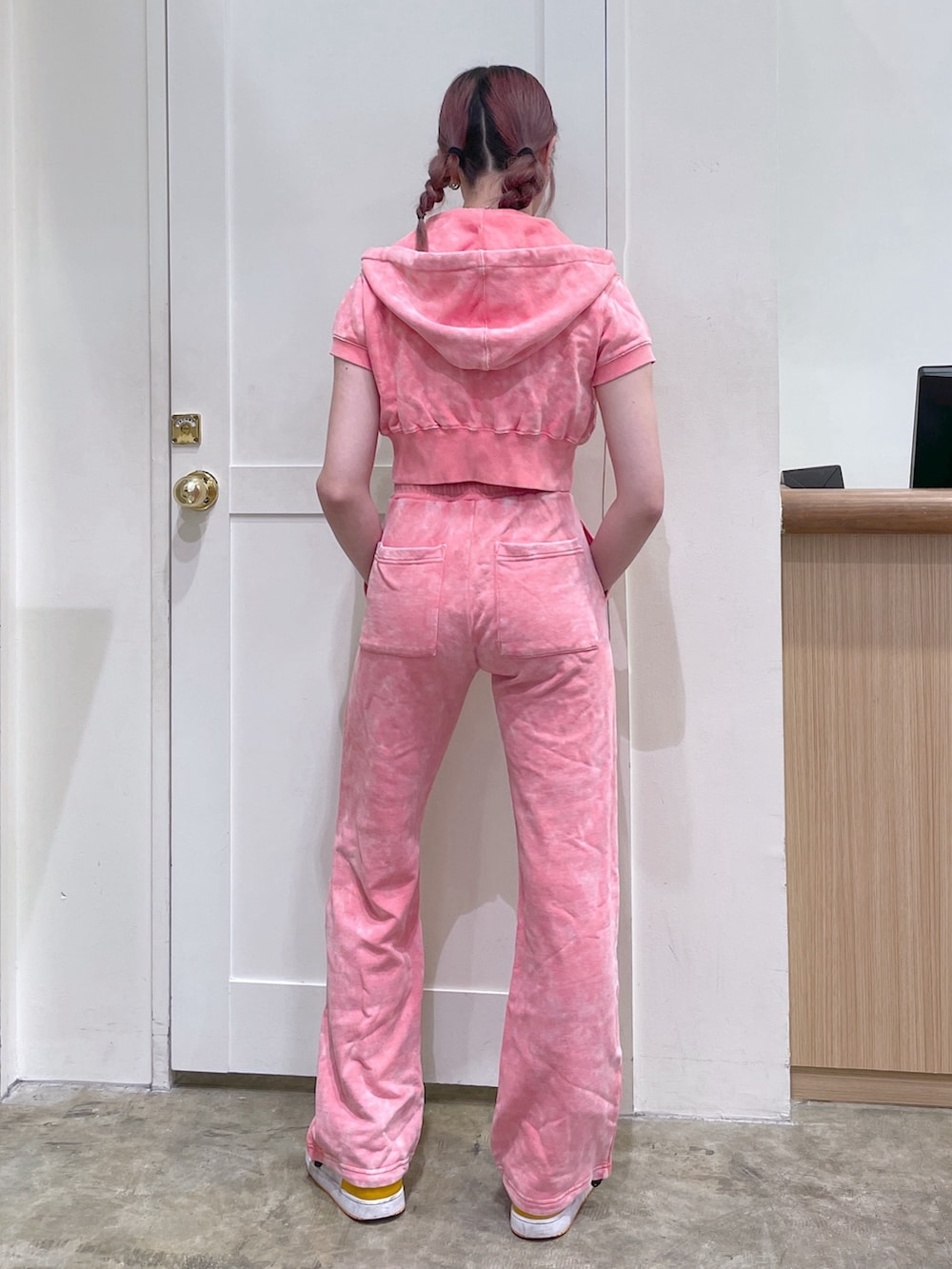 ピンク系のパーカー、ピンク系のスウェットパンツ、ホワイト系のタンクトップを着用したメンズの春コーディネートの3枚目の写真