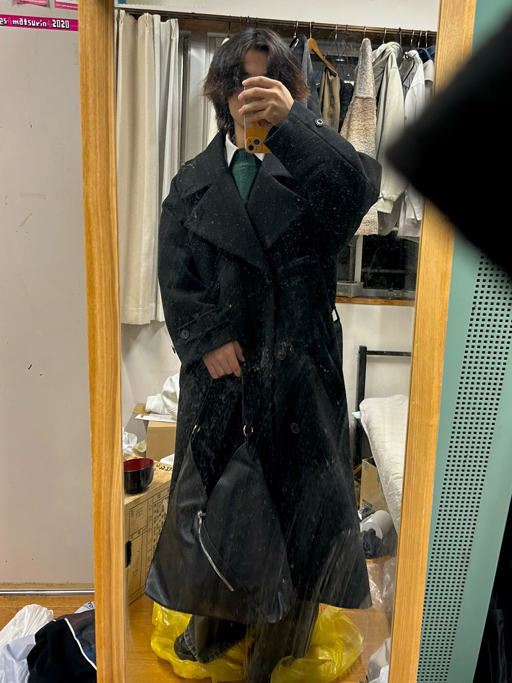 オレンジ系のデニムパンツ、グリーン系のニット/セーターを着用したメンズの冬コーディネートの3枚目の写真