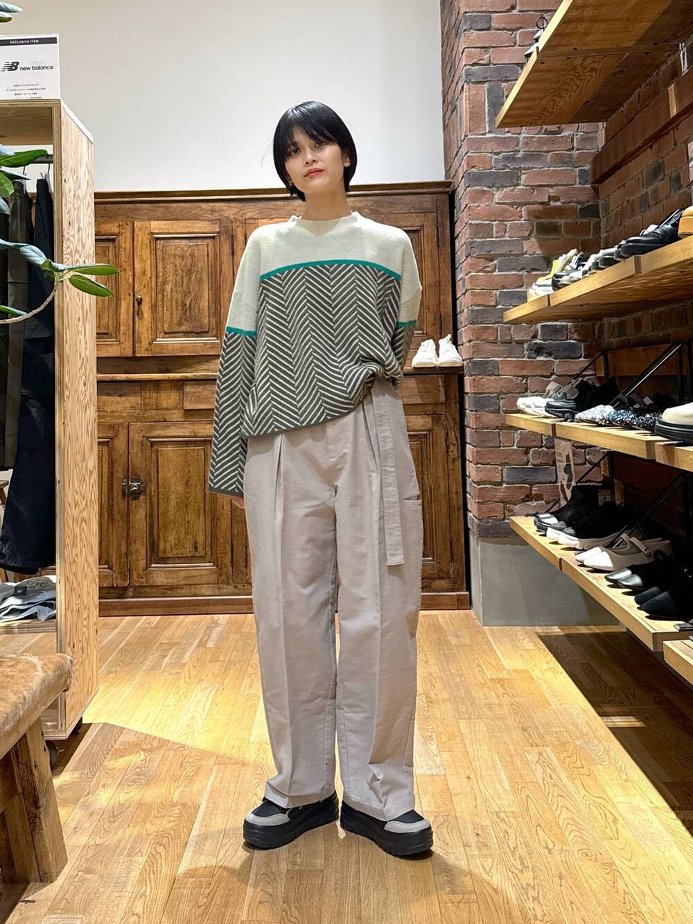 ベージュ系のその他パンツ、ブラウン系のニット/セーター、ブラック系のスニーカーを着用したレディースの冬コーディネートの3枚目の写真