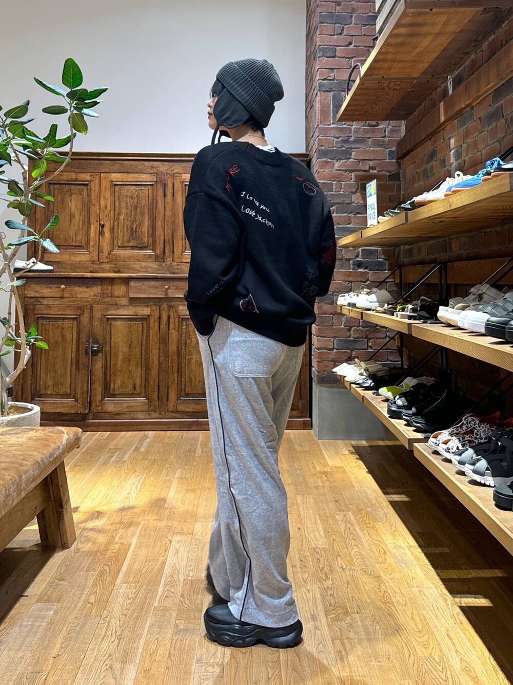 グレー系のその他パンツ、ブラック系のブーツ、ブラック系のカーディガン/ボレロを着用したレディースの秋コーディネートの4枚目の写真