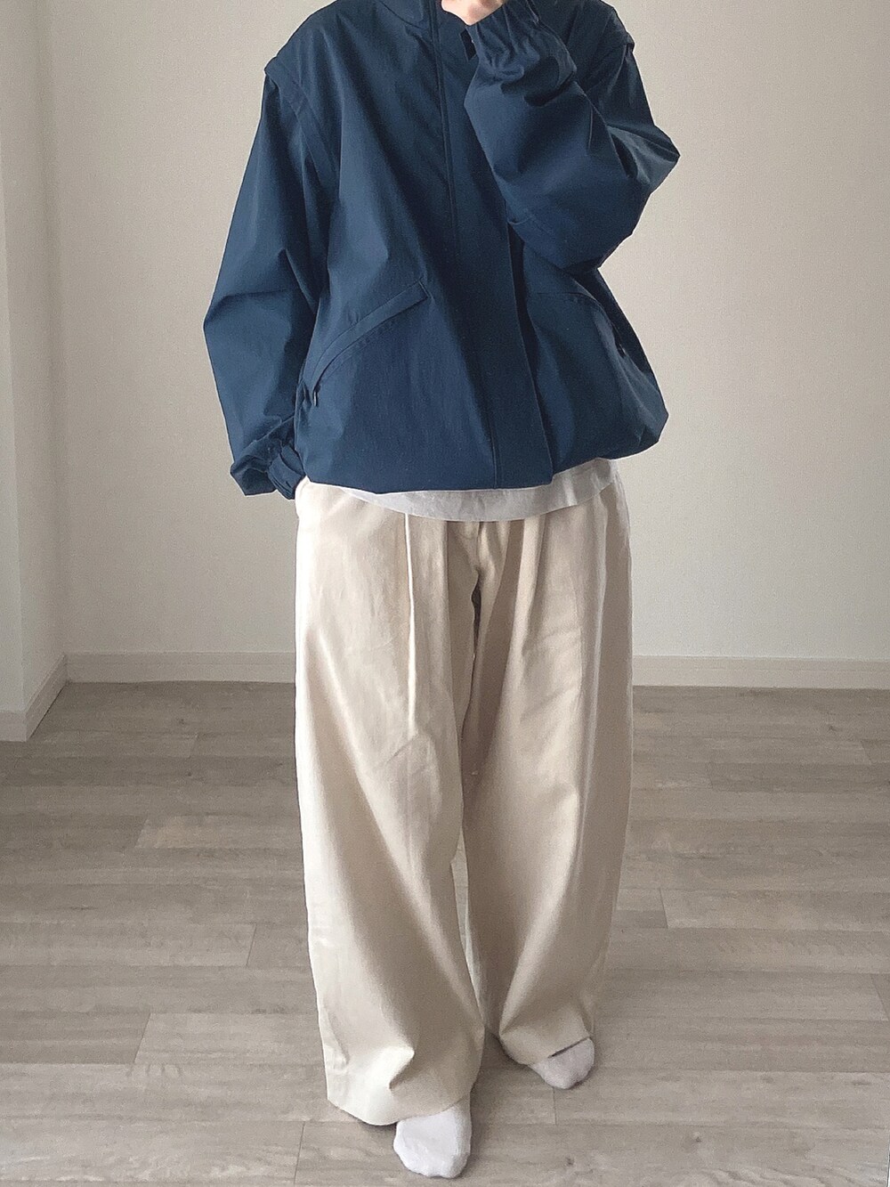 グリーン系のブルゾン、グレー系のTシャツ/カットソー、ホワイト系のその他パンツを着用したレディースの冬コーディネートの2枚目の写真