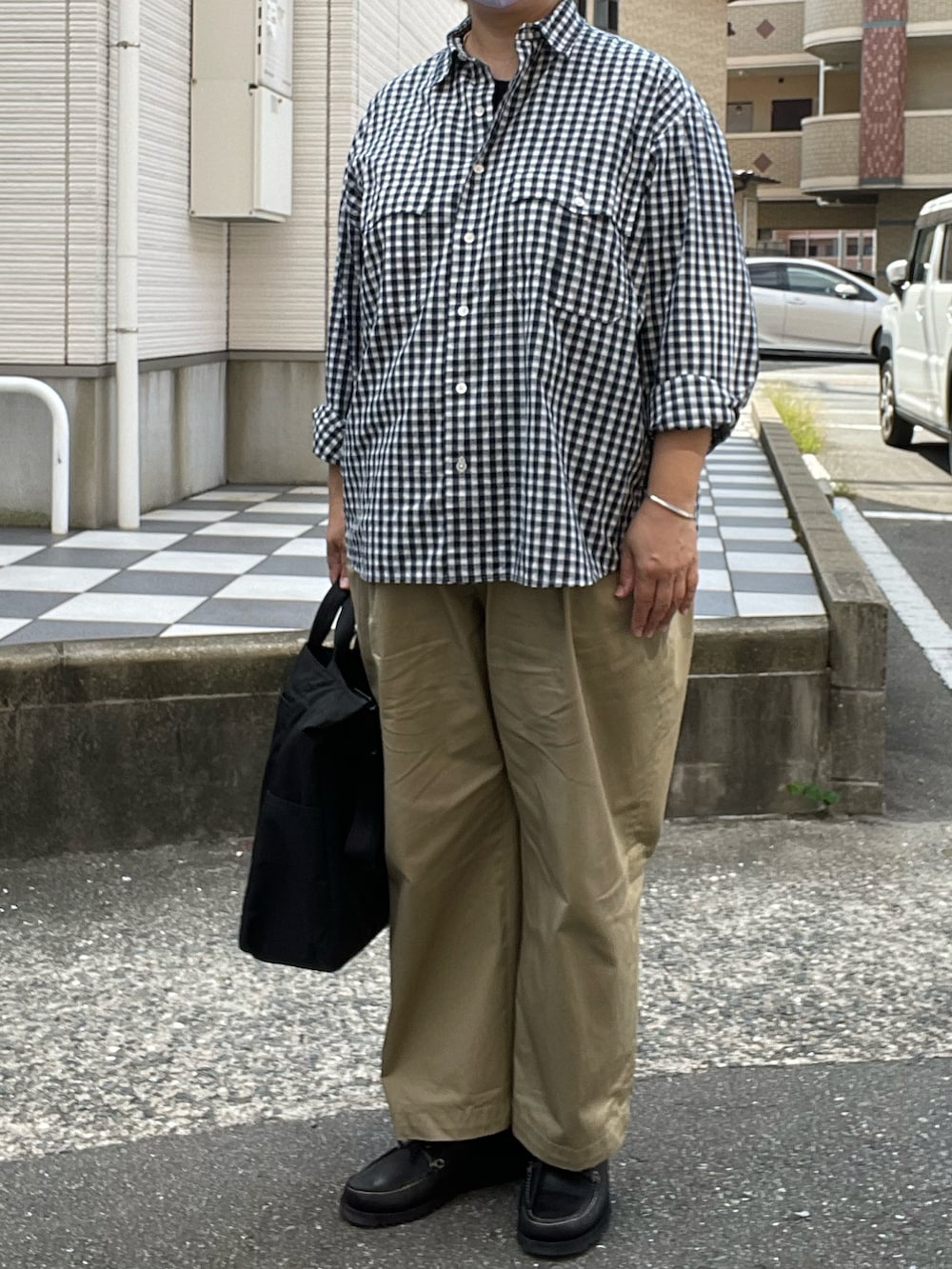 ベージュ系のチノパンツ、ブラック系のモカシン/デッキシューズ、ブルー系のシャツ/ブラウスを着用したレディースの秋コーディネートの2枚目の写真