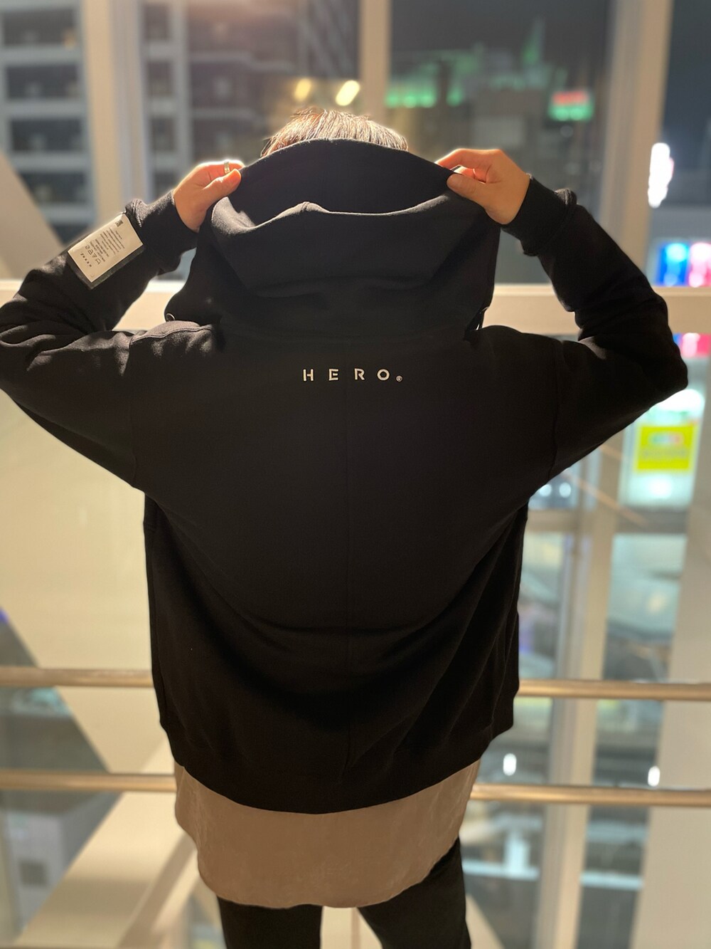 ブラック系のパーカー、ブラック系のチノパンツ、グレー系のニット/セーターを着用したメンズの冬コーディネートの3枚目の写真