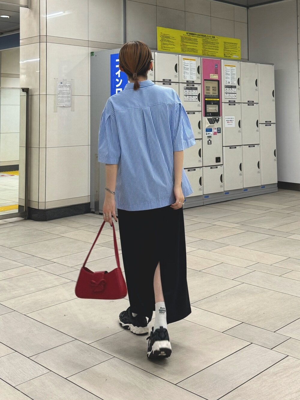 ブラック系のスカート、ブルー系のシャツ/ブラウス、ホワイト系のネックレスを着用したレディースの夏コーディネートの4枚目の写真