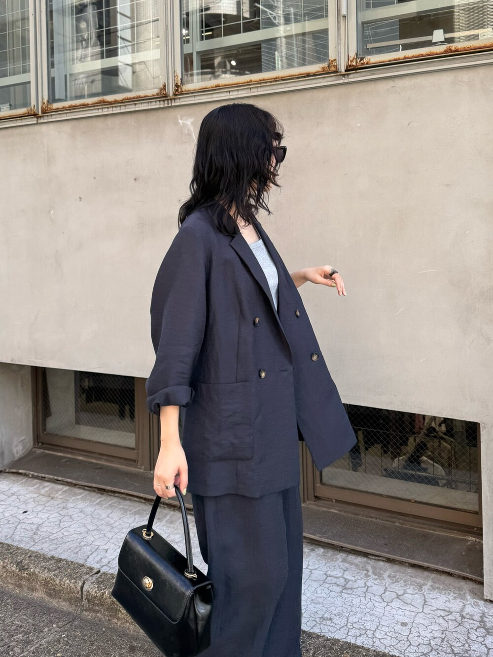 ブルー系のテーラードジャケット、ブルー系のその他パンツ、ブラック系のショルダーバッグを着用したレディースの春コーディネートの8枚目の写真