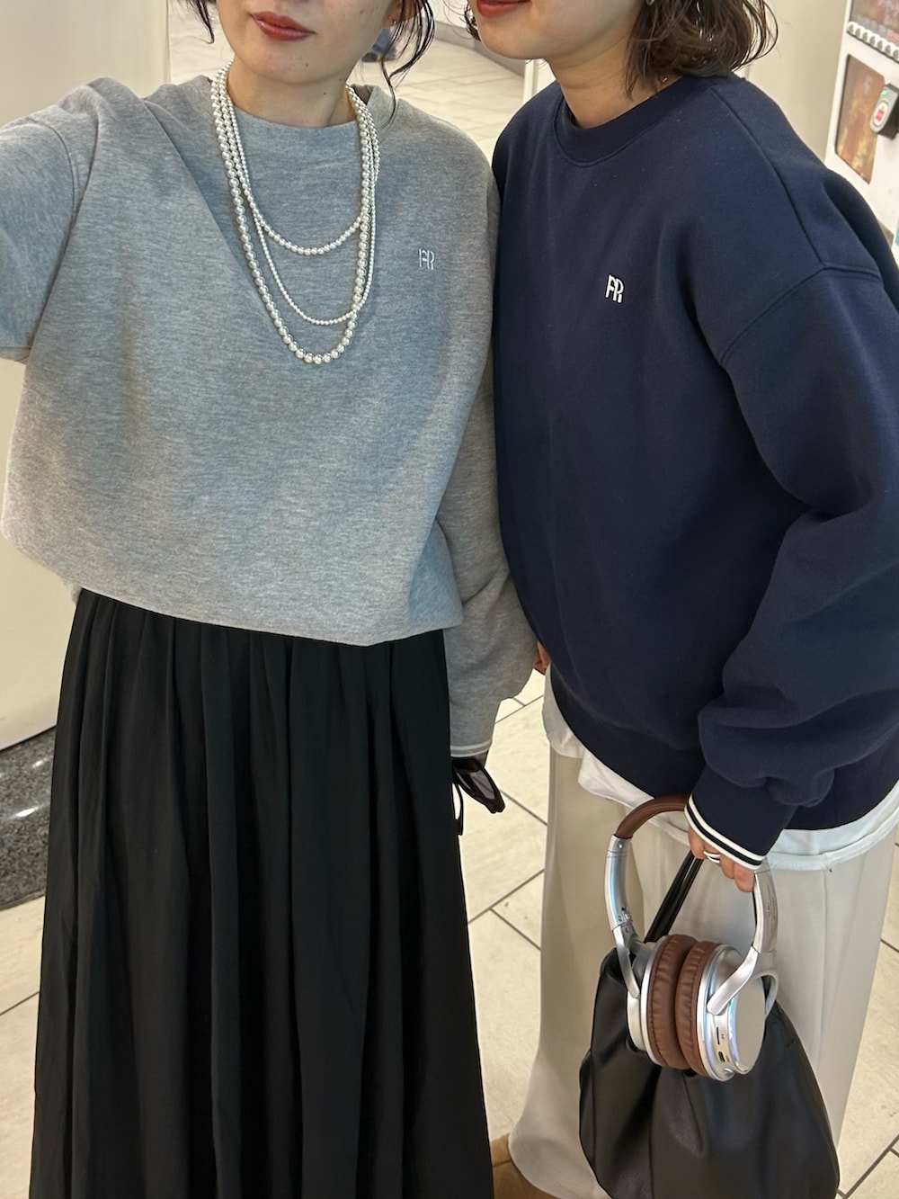 グレー系のスウェット、ブラック系のスカートを着用したレディースの冬コーディネートの4枚目の写真