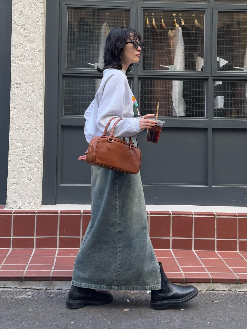 ブルー系のデニムスカート、イエロー系のショルダーバッグを着用したレディースの冬コーディネートの7枚目の写真