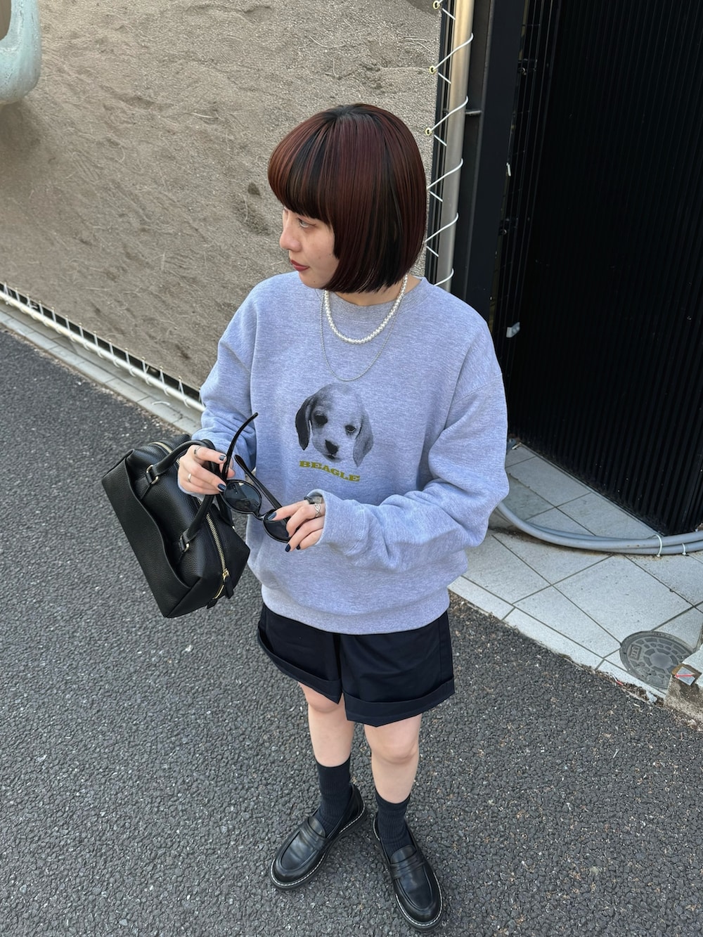 グレー系のスウェット、ブラック系のボストンバッグ、ブラック系のローファーを着用したレディースの春コーディネートの7枚目の写真